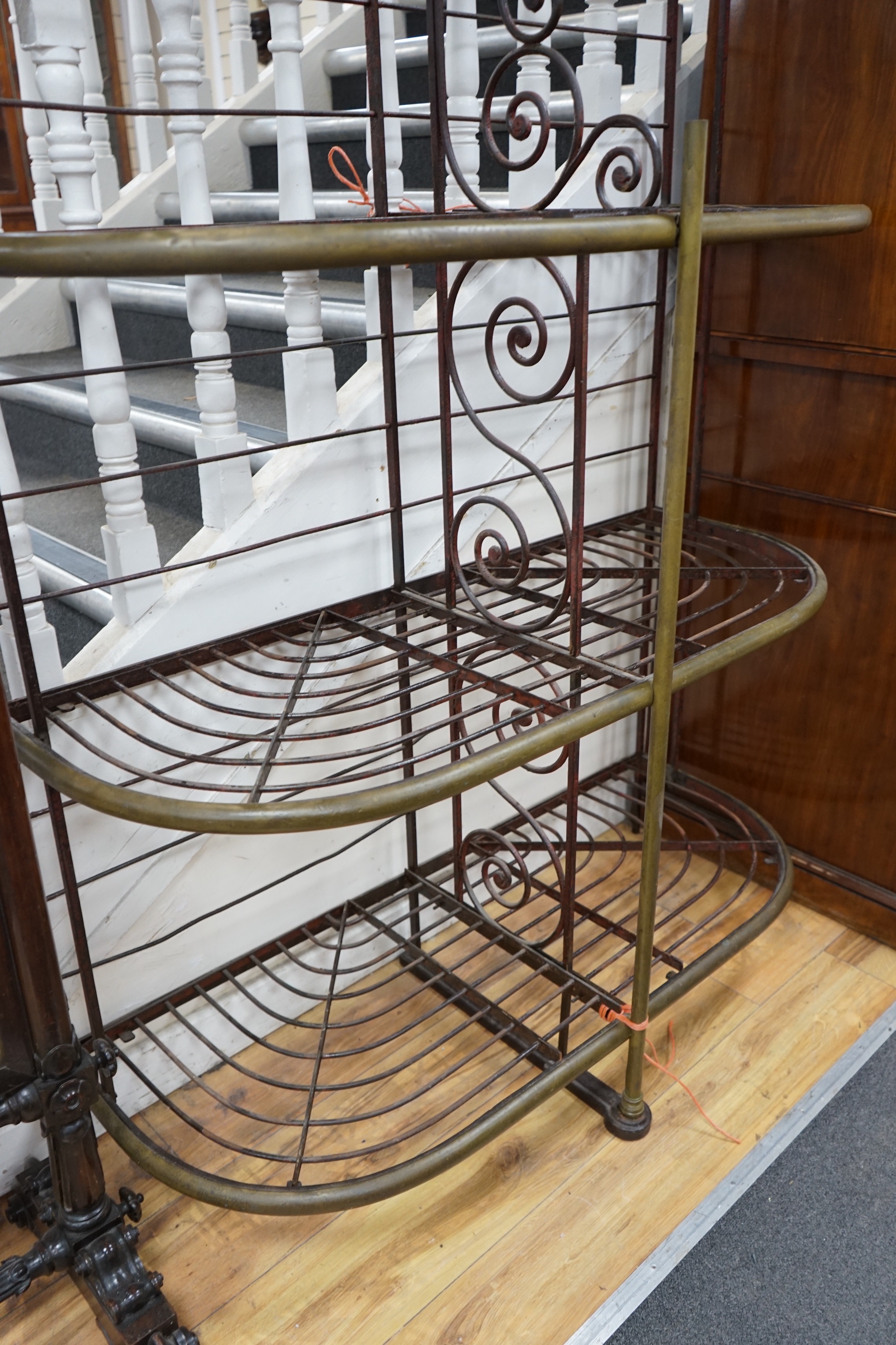 A 19th century French wrought iron and brass bakers rack, width 115cm, depth 46cm, height 215cm